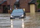 A car wades through water amid Storm Babet in Needham Market