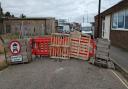 Residents add pallets as barriers to block traffic.