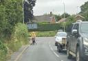 One of the pavements in Bramford, with a pedestrian walking on the road