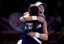 Katie Boulter, right, celebrates victory over Canada’s Leylah Fernandez with captain Anne Keothavong (Manu Fernandez/AP)