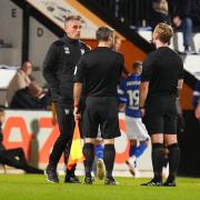 Ipswich Town manager Kieran McKenna speaks with the referee briefly at half time.