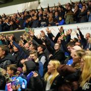 Town fans celebrate at the final whistle.