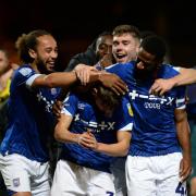 Cameron Humphreys is mobbed by his team-mates after the final whistle at Port Vale.