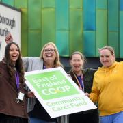 Suffolk Libraries team celebrate their Community Cares Fund donation at Gainsborough Library, Ipswich. (East of England Co-op/Warren Page)