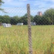 An event in Ipswich has been cancelled after travellers pitched up in a park