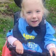 Bella Smythe, 4, has cerebral palsy and is taking part in the superhero challenge.