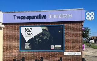 The Ipswich funeral home's window display is encouraging men to talk about their mental health.