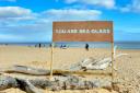 The artwork 'You are sea glass' created on Southwold beach by Adam Bridgland