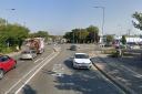 A road in Ipswich has been closed after a crash between a car and a motorcycle