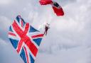 The paratroopers arrive for the pageant carrying the Union flag