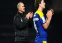 AFC Wimbledon boss Mark Robinson, left, says his team were 'harshly beaten' by Ipswich Town last night