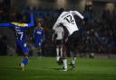 Tyreeq Bakinson shoots at AFC Wimbledon during the first half.