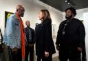 Democratic presidential nominee Vice President Kamala Harris talks to Delroy Lindo, left, at Norwest Gallery of Art in Detroit as Don Cheadle looks on from behind (Jacquelyn Martin/AP)