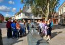 Young people at the Thomas Wolsey statue in Ipswich town centre.