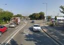 A road in Ipswich has been closed after a crash between a car and a motorcycle