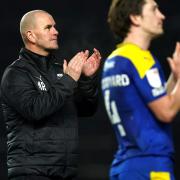 AFC Wimbledon boss Mark Robinson, left, says his team were 'harshly beaten' by Ipswich Town last night