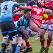 Woodbridge's Tom Stokes makes a big hit against Thetford. Picture: SIMON BALLARD