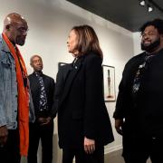 Democratic presidential nominee Vice President Kamala Harris talks to Delroy Lindo, left, at Norwest Gallery of Art in Detroit as Don Cheadle looks on from behind (Jacquelyn Martin/AP)