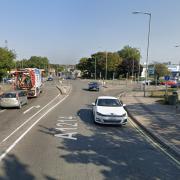 A road in Ipswich has been closed after a crash between a car and a motorcycle