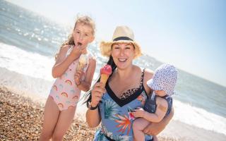 Temperatures are expected to soar this weekend, but experts say that it is unlikely they will exceed 40C. Pictured: Abigail, Gabi and Archie Chapman enjoying an ice cream.