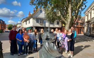 Young people at the Thomas Wolsey statue in Ipswich town centre.